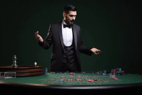 JILIHH Mobile App — Your complete hub for casino and sports A man focused on his laptop with live stats in the background, highlighting the dedicated sports and gaming features of the JILIHH mobile app.
