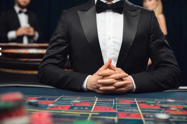 A woman in a luxurious green gown next to an ornate roulette wheel, capturing the upscale casino mood of JILIHH.