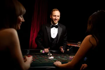A player using their smartphone during a festive local event, representing JILIHH’s fully mobile-friendly casino.